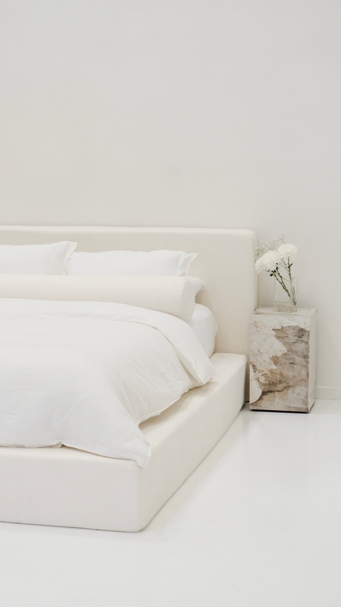 The ultimate Cloud Bed. Create cloud-like comfort in your bedroom with the dreamy CloudFrame bed. Upholstered in a soft, cream bouclè fabric, the bed features a contemporary square shape that redefines the concept of luxury in your bedroom. 